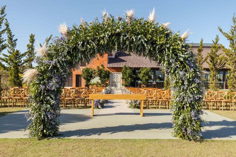 Outdoor wedding ceremony arch with beautiful floral arrangements